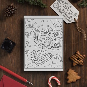 May include: A black and white coloring page featuring a child sledding down a snowy hill with a snowman in the background. The page is surrounded by a red envelope, a candy cane, and gingerbread cookies.