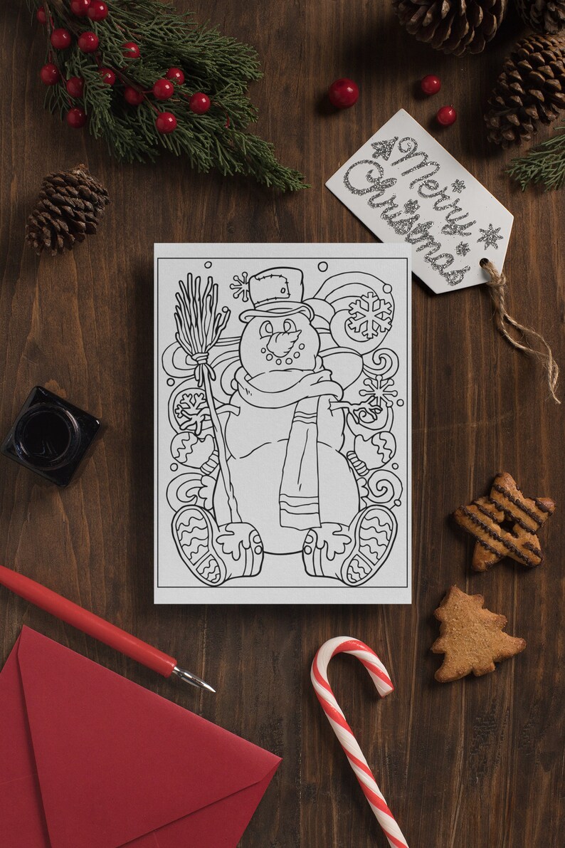 May include: A black and white coloring page featuring a snowman with a hat, scarf, and broom. The snowman is surrounded by snowflakes and swirls. The page is on a wooden table with a red envelope, a candy cane, and gingerbread cookies.