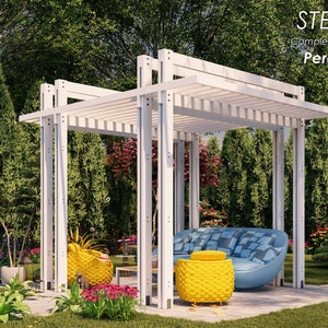 May include: A white wooden pergola with a slatted roof, measuring 12 feet 3 inches by 10 feet. The pergola is in a backyard setting with green trees and bushes. The pergola is furnished with a blue and white patterned sofa and two yellow chairs.
