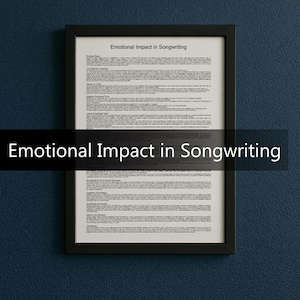 May include: A framed print titled "Emotional Impact in Songwriting" in a black frame. The print has a white background with black text. The frame is rectangular and is hanging on a dark blue wall.