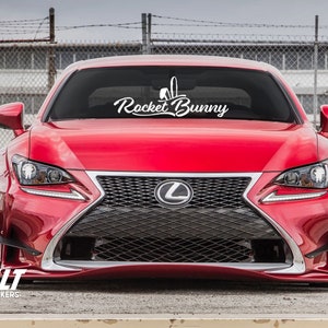 May include: A red Lexus RC F with a white "Rocket Bunny" decal on the windshield.