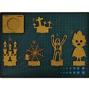 May include: A collection of laser-cut wooden Halloween decorations, including a castle, spiderweb with spider, skeleton, and a ghost-like figure. The pieces are various shapes and sizes, perfect for crafting or seasonal decor.