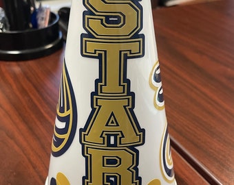 May include: White plastic megaphone with a gold and blue "STARS" design. The megaphone has a white background with gold and blue polka dots.