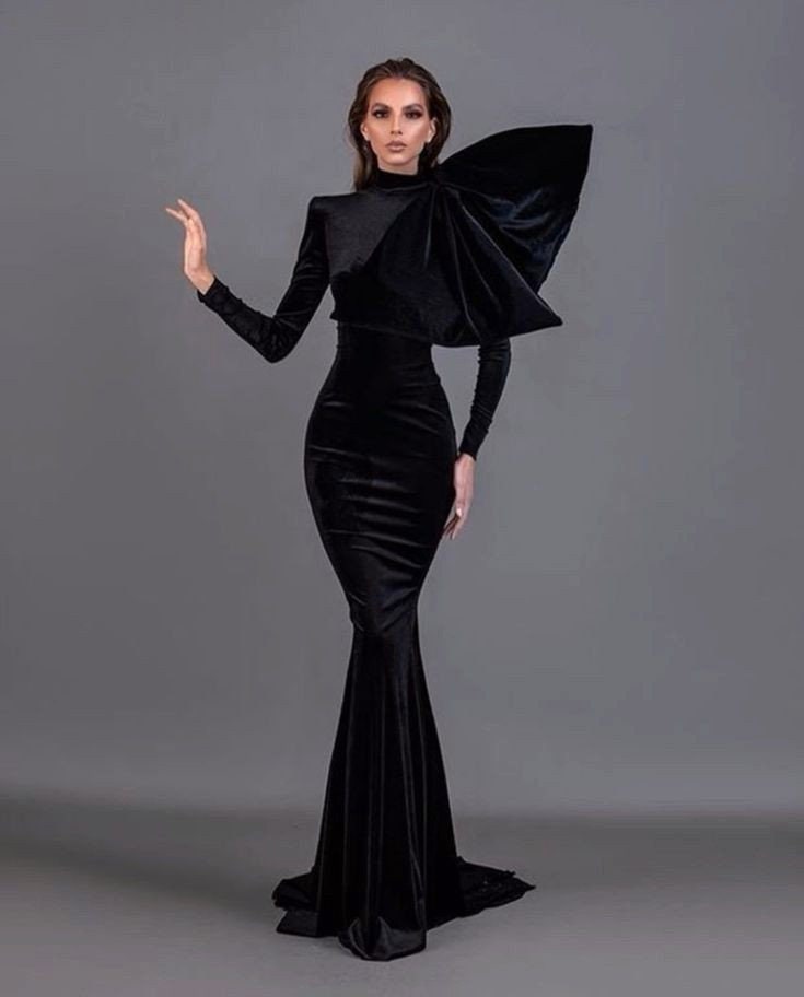 A BLACK VELVET EVENING GOWN