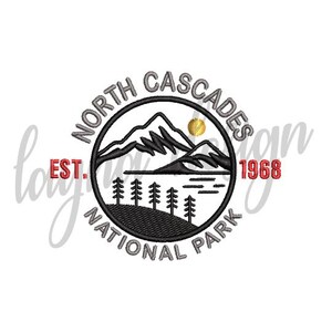 May include: Embroidered patch featuring the North Cascades National Park logo. The design includes mountains, trees, a lake, and a sun. The text reads "North Cascades National Park" and "Est. 1968". The patch is circular with black and gray details.
