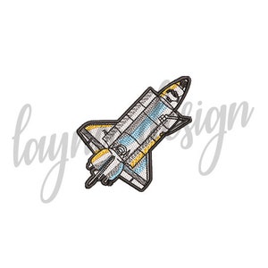 May include: Embroidered patch of a space shuttle in flight. The shuttle is grey and white with yellow accents.