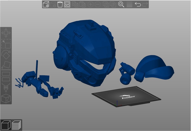 Peut inclure: Ensemble de pi&egrave;ces bleues imprim&eacute;es en 3D, comprenant un casque et divers composants, ainsi qu'une base rectangulaire avec le mot "Ender" imprim&eacute;. Les pi&egrave;ces sont dispos&eacute;es sur une surface grise.