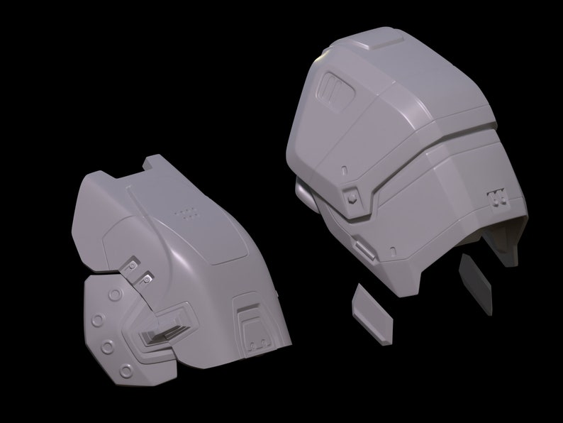 May include: A 3D printed model of a futuristic helmet, broken down into multiple pieces. The helmet is gray and has a textured surface.