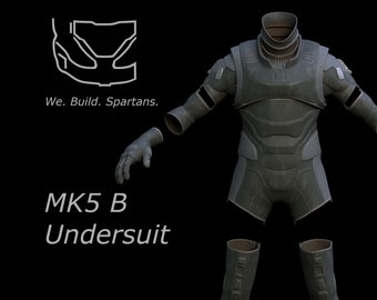 May include: A black and gray MK5 B Undersuit, a futuristic-looking suit with a textured surface. The suit is disassembled into separate pieces, including the torso, arms, and legs.