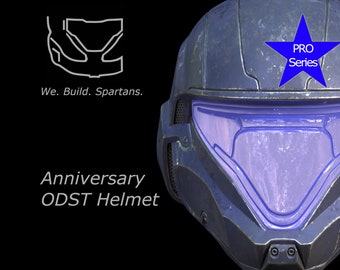 May include: A blue and gray helmet with a clear visor and a blue star with the text "PRO Series" on it. The helmet is labeled "Anniversary ODST Helmet".