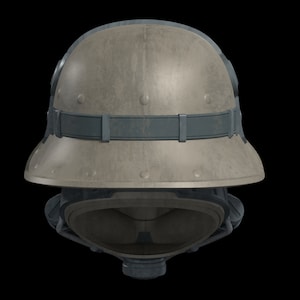 May include: A tan military helmet with a dark gray strap and a dark gray face mask. The helmet has a textured surface and a rounded shape.