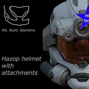 Può includere: Immagine dettagliata di un casco Hazop con accessori, dal design futuristico. Il casco è principalmente grigio con visiera color arancio e molteplici lenti circolari. È visibile una stella blu con la scritta "PRO Series". Il testo recita "We. Build. Spartans."