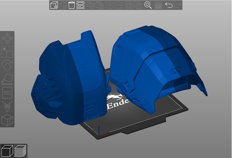 May include: Two blue 3D printed objects on a black print bed with the word "Ender" printed on it.