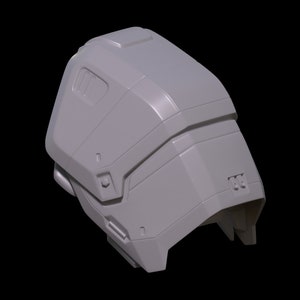 May include: A gray 3D printed model of a helmet with a futuristic design. The helmet has a smooth, rounded surface with several raised details and a small, rectangular window on the side.