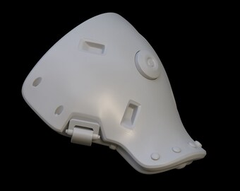 May include: A white plastic knee pad with a hinge and a round button on the side. The pad has several small holes and a textured surface.
