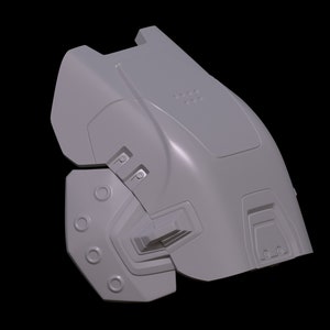 May include: A gray 3D model of a futuristic helmet with a textured surface and multiple details. The helmet is designed with a segmented structure, featuring a large, rounded top section and a smaller, more angular lower section. The helmet has a series of circular openings and raised ridges, giving it a mechanical and intricate appearance.