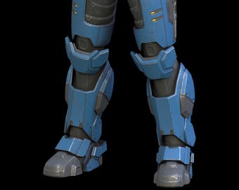 May include: Close-up of blue and gray robotic leg armor. The armor has a metallic appearance with visible wear and tear, suggesting a battle-worn aesthetic. The design incorporates angular shapes and segmented plates, with a dark background.