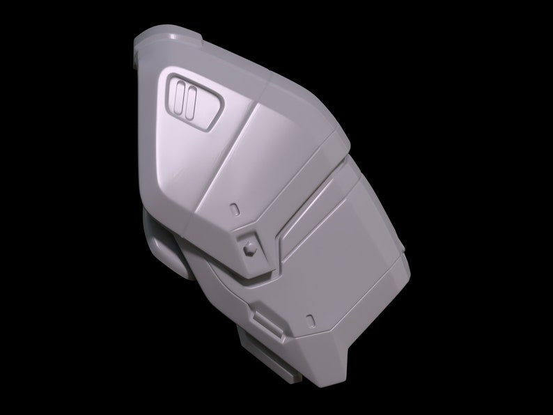 May include: A gray, textured, plastic piece with a geometric design. It has a rectangular shape with rounded edges and a series of raised lines and grooves.