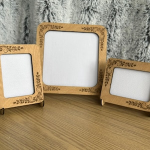 May include: A white ceramic mug with a black handle and the text "But First, Coffee" in a black, handwritten-style font. The mug is on a white surface.