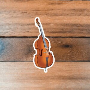 May include: A brown double bass with a white outline, on a woodgrain background.