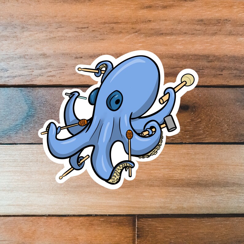 May include: A blue octopus with eight tentacles holding various percussion instruments, including mallets, drumsticks, and a small drum. The octopus is on a wooden background.