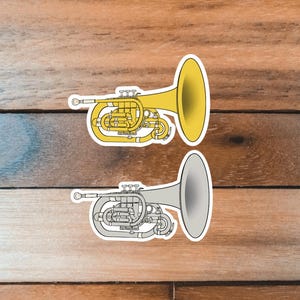 May include: Two illustrations of a flugelhorn, a brass instrument similar to a trumpet. One flugelhorn is yellow and the other is gray.