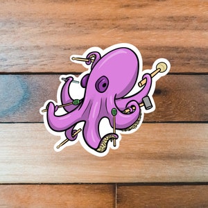 May include: A purple octopus with eight tentacles holding drumsticks and mallets. The octopus is cartoon-style and has a friendly expression.