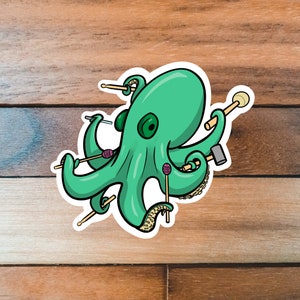 May include: A green octopus with eight tentacles holding various musical instruments, including drumsticks, a mallet, and a tambourine. The octopus is drawn in a cartoon style with a whimsical expression.