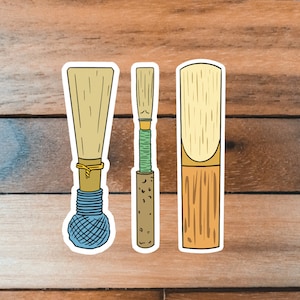 May include: Three different types of oboe reeds, each with a different design and color. The reeds are made of natural materials and are used to play the oboe.