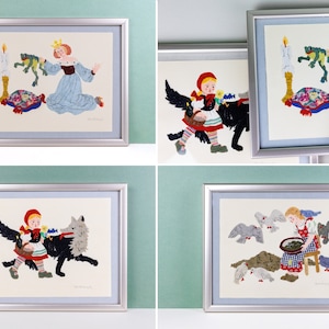 May include: Four framed illustrations of children's stories. Each frame has a silver colored frame and a white mat. The illustrations are in a whimsical style with bright colors. The first illustration shows a girl in a blue dress with a crown on her head, holding a frog. The second illustration shows a girl in a red dress and a red hood, walking with a black wolf. The third illustration shows a girl in a red dress and a red hood, walking with a black wolf. The fourth illustration shows a girl in a blue dress, feeding birds from a bowl.