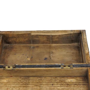 May include: An open, rectangular wooden box with a hinged lid. The box is made of light brown wood with visible grain and a distressed finish. The interior is also wooden, with brass hinges.