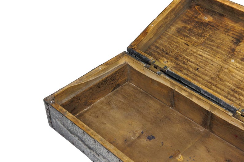 May include: An open, antique wooden box with a hinged lid. The box is made of light brown wood with visible grain and dark accents. The interior is also wooden, with a rectangular shape and a dark stain.