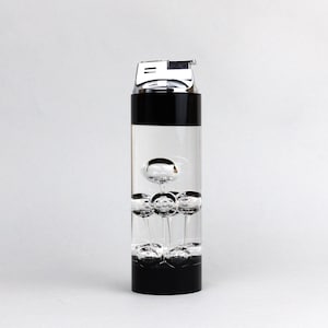 May include: A black and clear lighter with a floating bubble design. The lighter has a silver top and a black base.