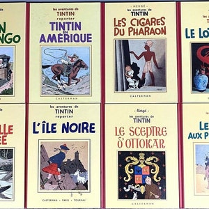 May include: A collection of eight vintage comic books featuring the adventures of Tintin, a young reporter. The books are all yellow with red spines and feature colorful illustrations of Tintin and his adventures. The titles of the books are "Tintin Au Congo", "Tintin En Amerique", "Les Cigares Du Pharaon", "Le Lotus Bleu", "L'Oreille Cassee", "L'Ile Noire", "Le Sceptre D'Ottokar", and "Le Crabe Aux Pince D'Or".