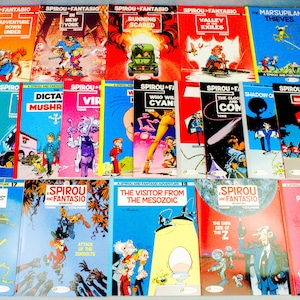 以下が含まれることがあります： イラストとテキストが特徴的な、カラフルな表紙のヴィンテージ スピルー＆ファンタジオ コミックのコレクションです。「オーストラリアの冒険」、「サーカスのパニック」など。