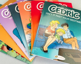 May include: A stack of eight colorful comic books featuring a cartoon character named Cedric. The top book is green and has the title "Cedric" and the text "Isn't it past your bedtime?" The other books have a white "C" logo on the cover.