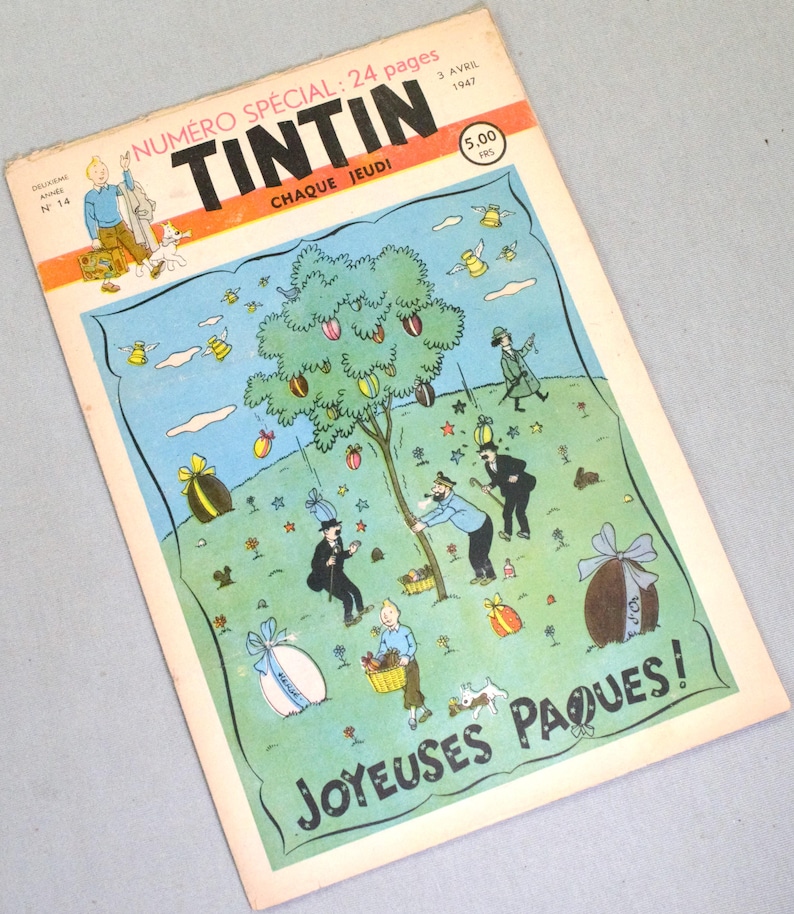 Puede incluir: Una portada de c&oacute;mic vintage de Tint&iacute;n del 3 de abril de 1947, titulada Num&eacute;ro Sp&eacute;cial: 24 pages Tintin. La ilustraci&oacute;n muestra personajes en un campo verde con un &aacute;rbol que tiene huevos coloridos y el texto Joyeuses P&acirc;ques! en la parte inferior.