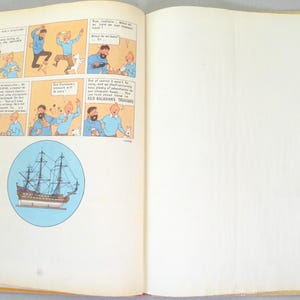 May include: Open book with a comic strip featuring cartoon characters in blue and white. A circular illustration of a tall ship is also present. The pages are yellowed with age, suggesting a vintage item.