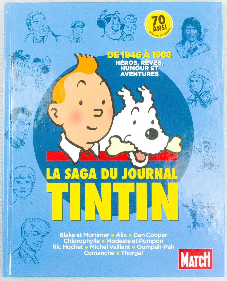 May include: A blue book cover featuring the character Tintin and his dog Snowy. The title "LA SAGA DU JOURNAL TINTIN" is in large yellow letters. The cover also includes the text "DE 1946 &Agrave; 1988" and "70 ANS!" with illustrations of other characters.