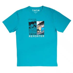 May include: A turquoise blue t-shirt with a graphic print of Tintin, a comic book character, in two panels. The text "Tintin Reporter" is printed below the graphic.