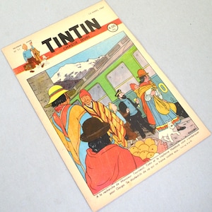 K&ouml;nnte beinhalten: Ein Vintage-Tintin-Comic-Cover vom 13. M&auml;rz 1947 mit einer farbenfrohen Illustration von Figuren in traditioneller andiner Kleidung neben einem gr&uuml;nen Zug. Der Titel Tintin ist oben in fetten schwarzen Buchstaben gedruckt.