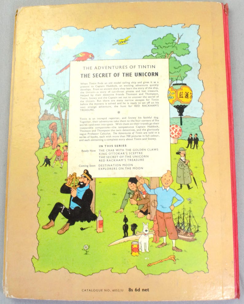 May include: The back cover of a vintage comic book titled "The Adventures of Tintin: The Secret of the Unicorn." The cover features colorful illustrations of characters, a ship, and text. The book is part of a series, with other titles listed.