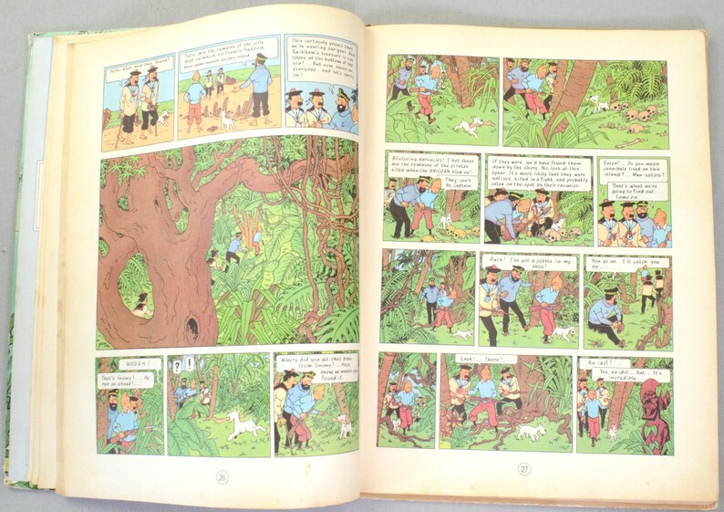 May include: An open book featuring comic panels with illustrations. The panels depict characters in blue shirts and red pants, exploring a jungle setting with a white dog. The artwork is in a classic comic book style, with speech bubbles.