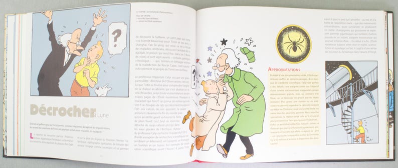 May include: An open book featuring comic illustrations. One panel shows a man in a suit gesturing at a young man with a dog, with the text "D&eacute;crocher Lune". Another panel depicts two men and a dog. A spider illustration is also visible.