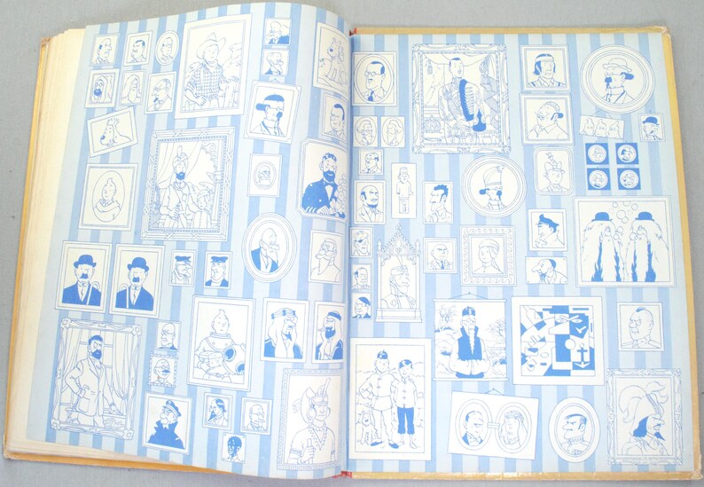 May include: Open book with pages featuring numerous blue and white illustrations of portraits and figures. The images are framed and arranged on a striped background, creating a gallery-like display.