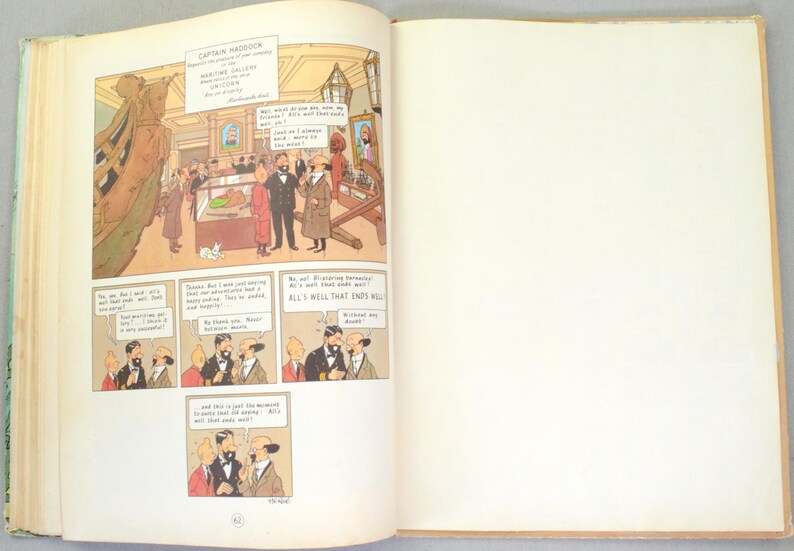 May include: Open book with a comic strip illustration. The comic strip features a museum scene with characters in suits and coats, and speech bubbles. Text at the top reads "CAPTAIN HADDOCK". The right page is blank.