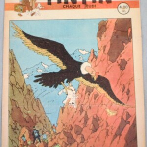 May include: A vintage Tintin comic book cover dated August 28, 1947, featuring a large black eagle carrying a white dog over a rocky mountain landscape. The title Tintin is printed in bold black letters at the top with the text Chaque Jeudi.