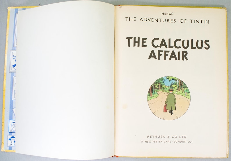 May include: An open book featuring the title page of "The Calculus Affair" from the Tintin series. The page has the title in large, bold letters, a circular illustration of a man walking on a road, and the publisher's information.