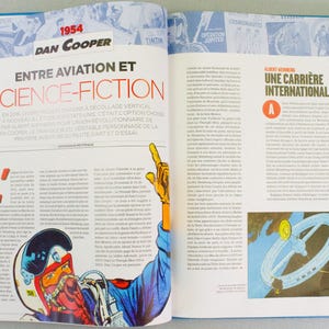May include: An open book with a blue cover, featuring articles and illustrations. The left page has the title "ENTRE AVIATION ET SCIENCE-FICTION" and a comic illustration. The right page has the title "UNE CARRI&Egrave;RE INTERNATIONALE" and a cartoon drawing.