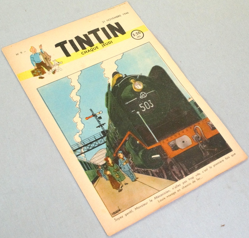 May include: A vintage Tintin comic magazine cover dated 21 November 1946, featuring a large dark green steam locomotive numbered 503 at a train station. The illustration includes a small figure of Tintin and his dog, with French text.